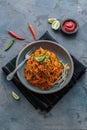 Indian mee goreng, spicy fried noodles in a plate, Singaporean and Malaysian cuisine copy space Royalty Free Stock Photo