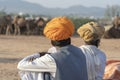 Indian men and herd camels during Pushkar Camel Mela, Rajasthan, India Royalty Free Stock Photo