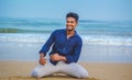 Indian men model posing and smiling on beach sea view background. Handsome and confident men. Outdoor portrait of smiling young Royalty Free Stock Photo