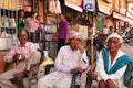 Indian men relaxing, working, sitting, smoking and talking in Vi