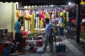 Indian men selling flower garlands at the night market