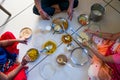 Hands of indian men and women having traditional gujarati thali lunch on floor for being of low caste