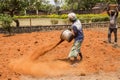Indian men at work with seal to move the orange earth to cultivate food vegetables grass