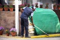 Indian men worker cleaner cleaning floor at patio park garden of department store at Delhi city morning before start thai festival