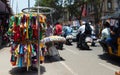 Indian merchant sell clothes on the pavement on a busy road