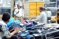 Indian merchant sell clothes on the pavement on a busy road