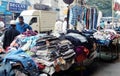 Indian merchant sell clothes on the pavement on a busy road