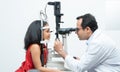 Indian middle aged professional ophthalmologist or optometrist man work at optometry clinic, using optometry instruments