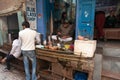 Indian milkman prepares the popular drink lassi in Blue lassi shop