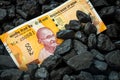 Indian money sticking out of a pile of coal, 200 rupee banknote, Concept of Mining in India, Rising coal prices, Environmental
