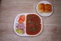 Indian Mumbai food Pav Bhaji from vegetables with bread close-up in a bowl on the table. horizontal top view from above Royalty Free Stock Photo