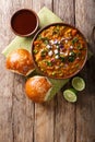 Indian Mumbai food Pav bhaji from vegetables with bread close-up in a bowl. Vertical top view Royalty Free Stock Photo