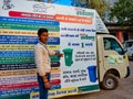 indian munciple corporation male worker showing hand to the promotional vehicle on road in India January 2020
