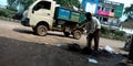 Indian munciple corporation worker collecting dirty mud from sewage on road side in india oct 2019