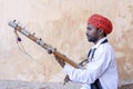 Indian musician play on traditional music instrument for tourists. India Royalty Free Stock Photo