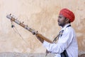 Indian musician play on traditional music instrument for tourists. India Royalty Free Stock Photo