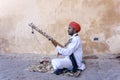 Indian musician play on traditional music instrument for tourists. India Royalty Free Stock Photo