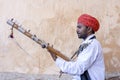 Indian musician play on traditional music instrument for tourists. India Royalty Free Stock Photo