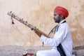 Indian musician play on traditional music instrument for tourists. India Royalty Free Stock Photo