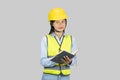 Female Asian Construction Engineer with chartboard and notebook gives expressions, gestures