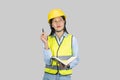 Female Asian Construction Engineer with chartboard and notebook gives expressions, gestures