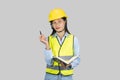 Female Asian Construction Engineer with chartboard and notebook gives expressions, gestures