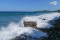 Indian ocean coastline near Bali island. Big waves hitting the stony beach and attacking the rocky coast. Water sprays. Royalty Free Stock Photo