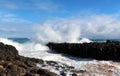 Indian Ocean waves dumping against dark basalt rocks on Ocean Beach Bunbury Western Australia