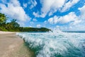 Indian Ocean Waves Spray and beach in Background. Seychelles, Mahe Island. Royalty Free Stock Photo