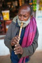 Indian old man blowing horn Royalty Free Stock Photo