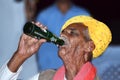 Indian old man drinking cold drink