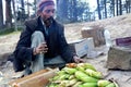 An Indian old man sale Bhutta Fire Roasted Corn street food