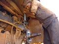 an indian old mechanic putting grease oil into the truck wheel during oiling work at automobile service center in India dec 2019 Royalty Free Stock Photo