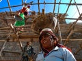 an indian old woman transporting raw material on head during home construction in india January 2020