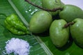 INDIAN OLIVE FRUITS WITH GHOST CHILI PEPPER BHUT JOLOKIA AND SALT ON A BANANA