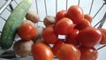 Indian organic shiny red tomatoes, organic potatoes and organic cucumber.