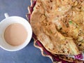 Indian Pakistani breakfast aloo wala paratha with tea