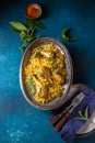 Indian or Pakistani food. Chiken Biryani rice biriany with mint herb and naan bread on blue background