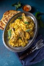 Indian or Pakistani food. Chiken Biryani rice biriany with mint herb and naan bread on blue background