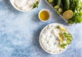 Indian or Pakistani raita sauce or dip with cucumber, yoghurt, garlic and mint, blue concrete background. Traditional Indian