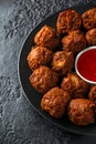 Indian Pakora snack spicy onion, red pepper with chilli sauce in a black plate