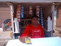 an indian pan shopkeeper offering pan masala pack to the customer at street shop in india dec 2019 Royalty Free Stock Photo