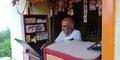 An indian pan shopkeeper operating laptop computer system at shop Royalty Free Stock Photo