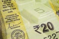 Indian paper money. Fragment of banknote of 20 rupees and calculator button close-up. Economic calculation and investments. Credit