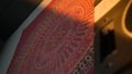 Indian pattern on the fabric and a music speaker nearby Royalty Free Stock Photo