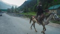 Indian people foreigner ride a horse in Leh main bazaar at Leh Ladakh city on July 1, 2017 in Jammu and Kashmir, India