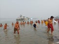 Indian people performing rituals of Makar Sankranti, the Ganges puja or worship in black polluted water Royalty Free Stock Photo