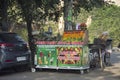 Indian people sale and buy juice shake fruits vegetables from small local grocery stall shop in New Delhi, India