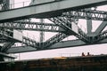 Indian people standing on Howrah Bridge, Steel Structure in the afternoon with rain in Kolkata, India