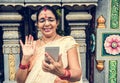 Indian people using mobile phone at the colorful temple